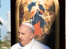 Pope Francis speaks at the at the Grotto of Lourdes in the Vatican Gardens on May 31, 2021, against the backdrop of an image of Our Lady, Undoer (or Untier) of Knots.